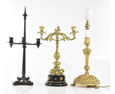 An ormolu candlestick with cast Rococo style decoration, mounted on marble plinth base, height 40cm, a gilt brass twin branch