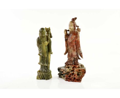 A Chinese hardstone model of an elder with carved deer and decoration to garments, height 36cm, and a Chinese green hardstone