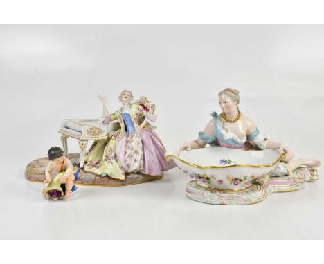 MEISSEN; a 19th century centrepiece modelled as a scantily clad maiden leaning on an oval shaped bowl, with floral encrusted 