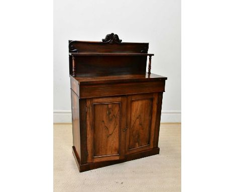 A Victorian rosewood chiffonier, with carved back above single frieze drawer and two panelled cupboard doors, on plinth base,
