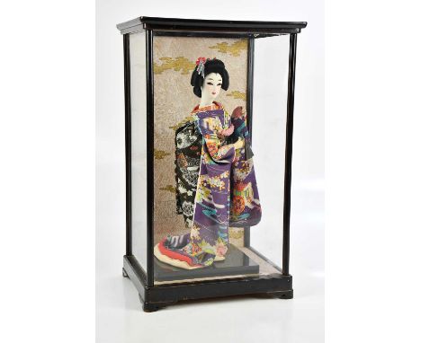 A cased model of a geisha in traditional Japanese dress, overall height 45cm.