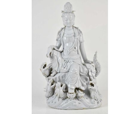A Chinese Blanc de Chine model of Guanyin seated on four dragons, height 49cm.Condition Report: Light surface wear and minor 