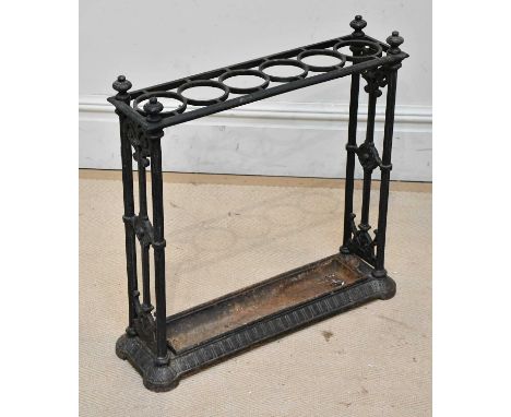 A cast iron six division stick stand of rectangular form, with detachable drip tray, length 61cm.