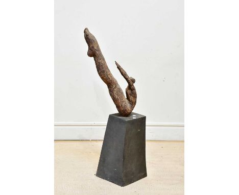 A contemporary ceramic driftwood effect sculpture representing a diver, on a stone base, height 128cm.