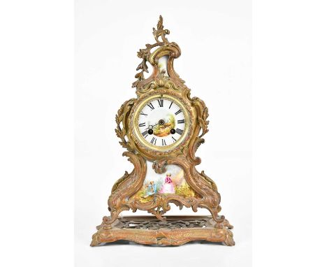 A late 19th century French Rococo style gilt metal mantel clock, with porcelain face and panels set with Roman numerals and l