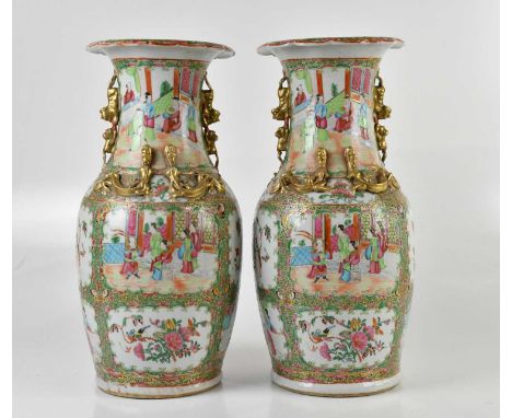 A pair of 19th century Chinese Canton vases, with moulded handles and creatures climbing the vase, with wavy rims and painted