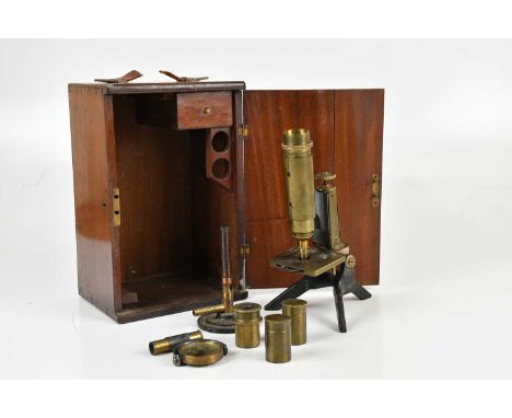 A mahogany cased monocular microscope, with additional lenses.