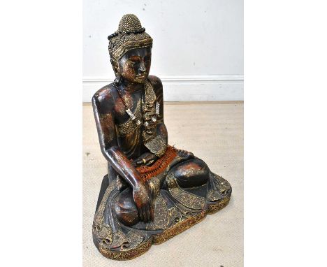 A large and impressive decorative carved and gilt wood model of a seated Buddha, with jewelled detail and later necklace and 