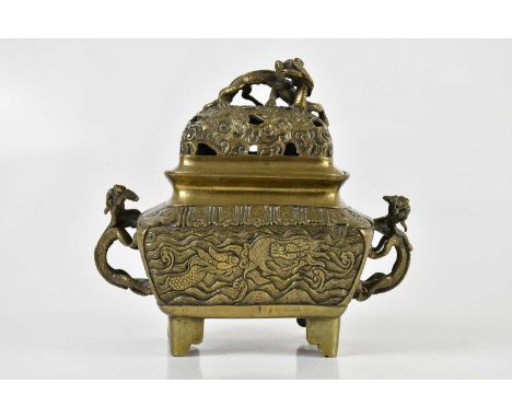 A Chinese bronze censer and cover, the pierced cover with applied mythical creature above two creatures climbing forming hand