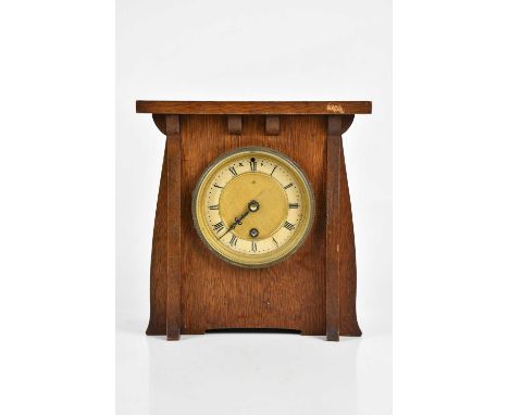 An Arts and Crafts oak mantel clock, the dial set with Roman numerals, with replacement quartz movement, height 24cm, width 2