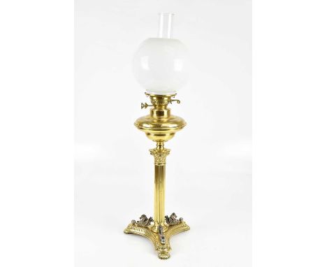 A Victorian style Corinthian column oil lamp, with milk glass bulbous shade above the Corinthian column and the tri-base mode