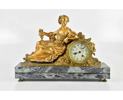 A late 19th century gilt bronze figural mantel clock representing a maiden with a floral wreath in her hair, seated with ewer