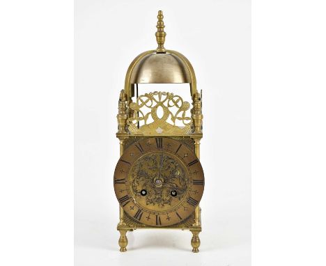 A French lantern type carriage clock, with urn finial above three pierced panels and applied chapter ring bearing Roman numer