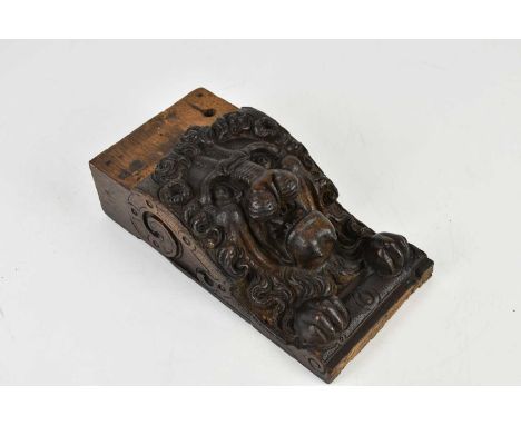 An antique carved oak corbel, possibly Danish, of a lion head with paws, 27 x 13cm.