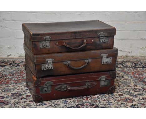Three vintage suitcases including a leather bound example, with vintage label 'Norwegian Coastal Service' and initials 'WP', 