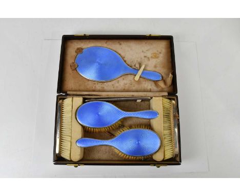 GOLDSMITHS &amp; SILVERSMITHS; a George V hallmarked silver and blue guilloché enamel eight piece dressing table set, London 