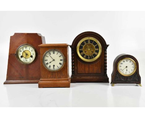 A 1920s oak mantel clock, the brass and black face set with Roman numerals flanked by barley twist columns, height 30cm, with
