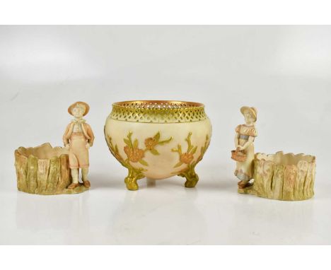 ROYAL WORCESTER; a pair of figures representing a boy and a girl holding a basket beside circular fence, also a Royal Worcest