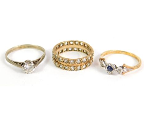 A 9ct gold sapphire and diamond three stone ring, in a heart shaped setting, size Q, zircon set full eternity ring, in yellow