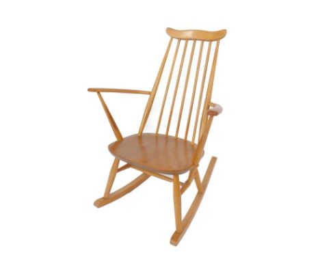An Ercol light elm and beech rail back rocking chair.
