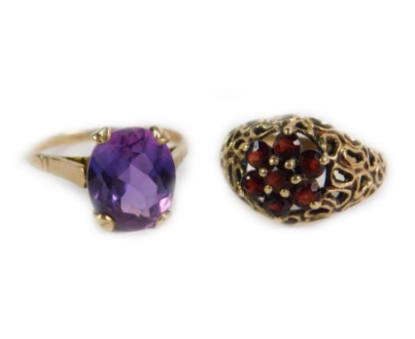 A 9ct gold and amethyst ring, oval cut high claw set, approx 5cts, size T, together with a 9ct gold and garnet flower head ri