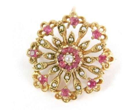 A ruby and seed pearl circular floral pendant brooch, set in yellow metal, 5.8g.