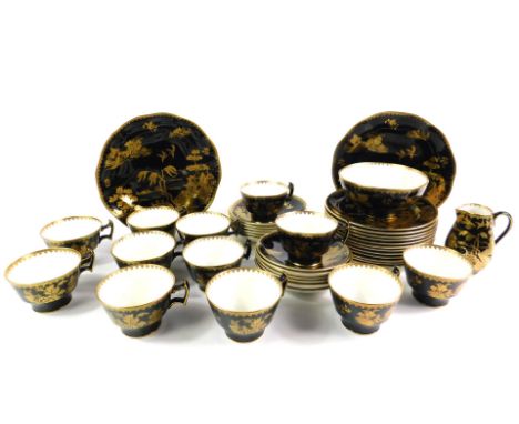 An early 20thC Booths pottery tea service, decorated in gilt with chinoiserie landscapes and floral sprigs against a black gr