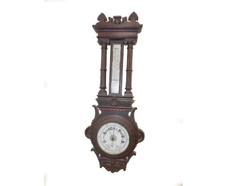 A Victorian oak cased wall barometer by T B Winter &amp; Son, Newcastle on Tyne, with barometer, the case with Greek carving,