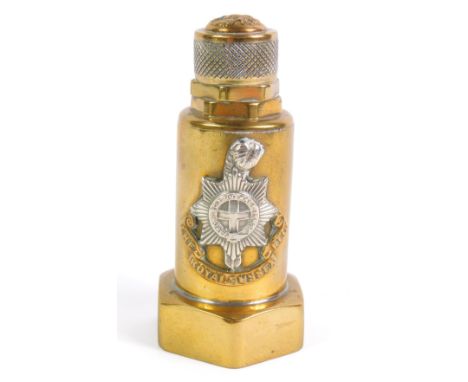 A World War I trench art paperweight, formed of a brass barrel and screws, set to the top with a button and to the front with