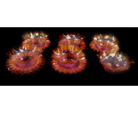 A set of six Stevens &amp; Williams late 19thC cranberry glass finger bowls, of frilled form with amber threaded edges, toget