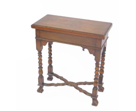 A William &amp; Mary style walnut and oak fold over card table, with a rectangular top, raised on barleytwist supports, unite