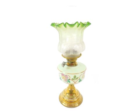 A Victorian duplex brass oil lamp, with a green glass reservoir painted with flowers, with chimney and frosted clear to green