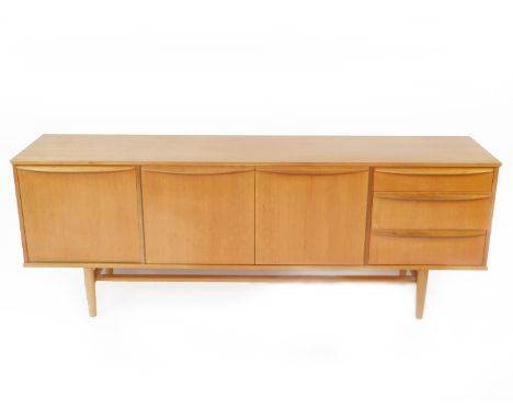 A 1960's Morris of Glasgow teak sideboard, with two central doors opening to reveal a single shelf, flanked by a drop down dr