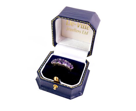 A 9ct gold and amethyst five stone ring, the graduated amethyst set with pairs of old cut diamonds at intervals, size R, 5.8g