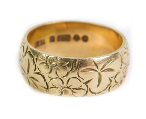 A 9ct gold wedding band, with engraved floral decoration, size R, 7.8g.