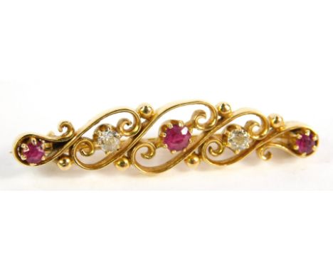 A 9ct gold ruby and diamond five stone brooch, in a scrolling design, 4.5g.