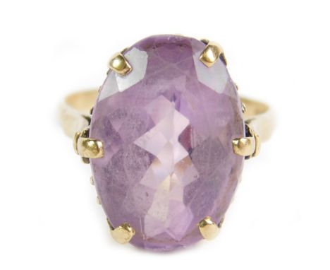 A 9ct gold and oval cut amethyst ring, claw set, approx 16cts, size V, 7.7g.