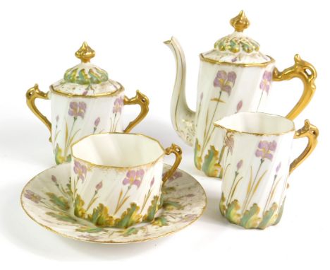 An early 20thC Limoges porcelain solitaire set, of spiral fluted form, decorated and gilt heightened with irises, printed mar