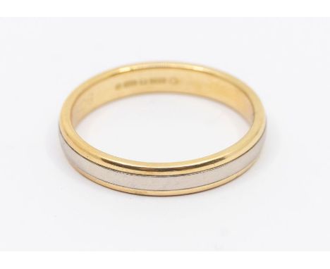 A two tone 18ct gold ring, comprising a central; wide band of white gold within yellow gold borders, width approx 4mm, size W