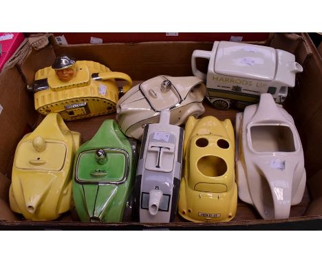 Three Art Deco Sadler Racing Car teapots, one with lime green glaze and silver trim, one with cream glaze and silver trim, on