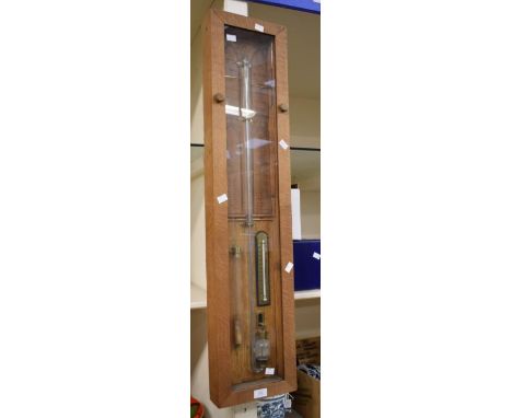 A reproduction rectangular Admiral Fitzroy's mercury Barometer in an oak case. Approx. 23.5cm wide and 101cm high.