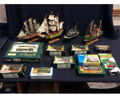 A collection of Corgi boxed classics, with some loose, and four wooden Boats on stands.