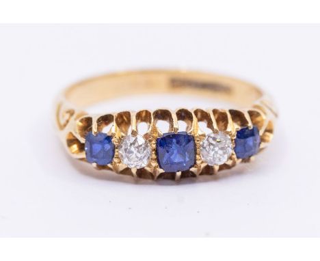 A Victorian sapphire and diamond five stone 18ct gold ring, comprising three cushion shaped gradated sapphires with two old c