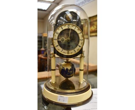 A Raiser Torsion 400 day clock (with instructions under glass dome) movement stamped with makers name, world globe at top of 