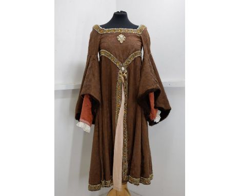 A childrens costume based on an early portrait of Elizabeth I, when she was a girl, the dress is in brown brocade, edged in g