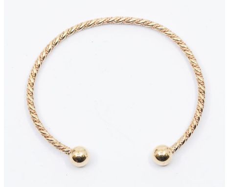 A Clogau welsh gold two colour 9ct gold rope twist torque bangle, comprising a twisted rope design with bead terminals, inter