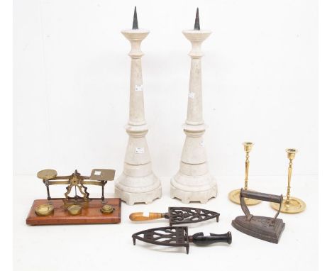 A collection of metalware to include: two free standing candle holders; a pair of alabaster candle holders, Victorian irons, 
