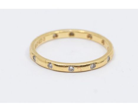 An 18ct gold and diamond eternity ring, comprising a narrow band set with twelve small round brilliant cut diamonds, width ap