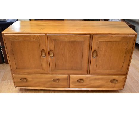 A light oak Ercol sideboard along with a drop leaf table