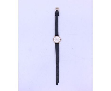 A ladies 9ct gold Rotary wristwatch, round silvered dial with applied baton markers, case approx 20mm, to a leather strap, to